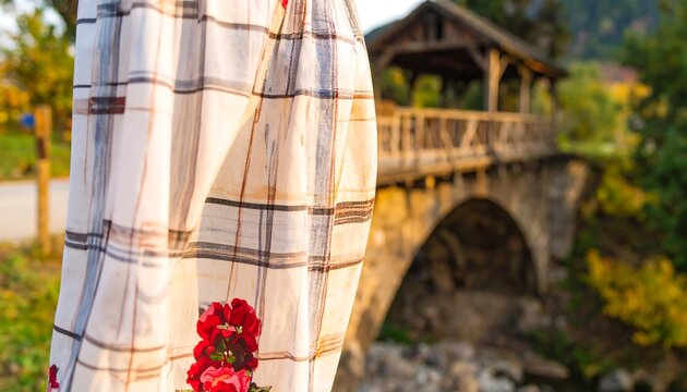 Checkered fabric draped near a wooden bridge