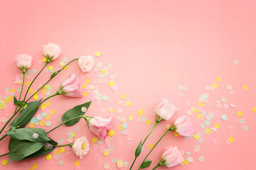Top view image of pink flowers composition over pastel background .Flat lay