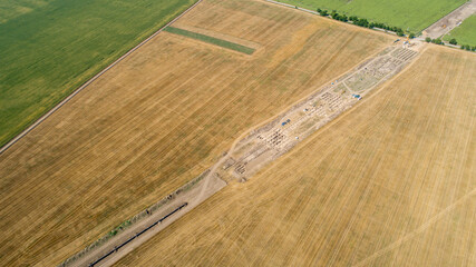 Aerial view of gas and oil pipeline construction and archeological excavations. Big pipeline is...