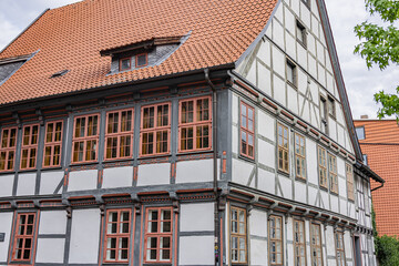 Traditional half timbered house with red framed windows and tiled roof in Göttingen, Germany