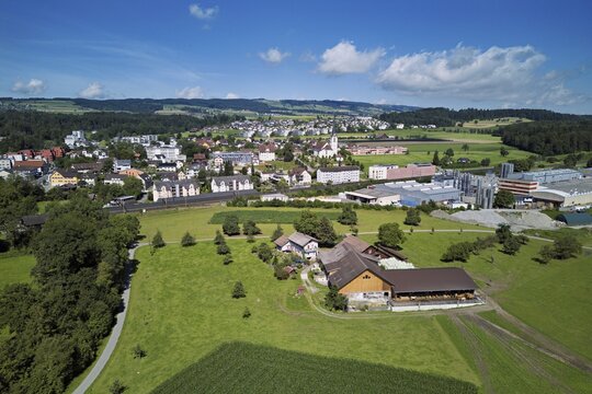 View of the village with the catholic parish church Mari&auml; Geburt, on the right the industrial area, Sins, Freiamt, Canton, Aargau, Switzerland