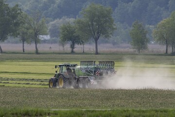 Tractor driving with slurry tanker, meadow, dust, drought, summer, Alpine foothills, Bad-Tölz district, Bavaria, Germany