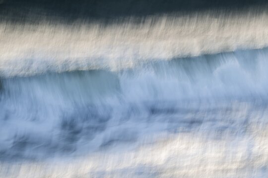 Dynamic waves with a blurred effect create a feeling of movement on the sea, near Hvide Sande, Jutland, Denmark