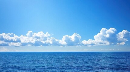 Obraz premium Calm Sea Under Blue Sky and White Clouds, Suitable for Natural Scenery, Ocean Landscape, Vacation Background and Other Scenarios