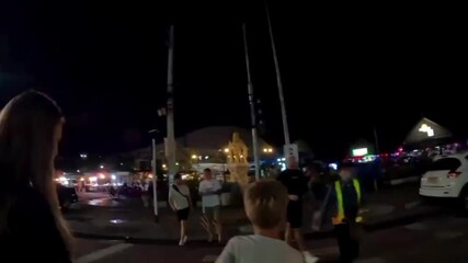 A first—person walk through the neon-drenched streets of Thailand's night market with scooters, street food stalls, and lively crowds is a vibrant urban video optimized for travel, nightlife.