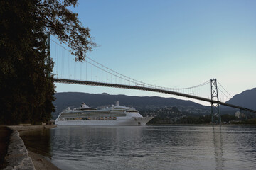 Modern cruiseship or cruise ship liner Serenade, Radiance, Brilliance or Jewel arrival into Vancouver port, Canada during sunrise after cruise to Alaska with Stanley Park landscape
