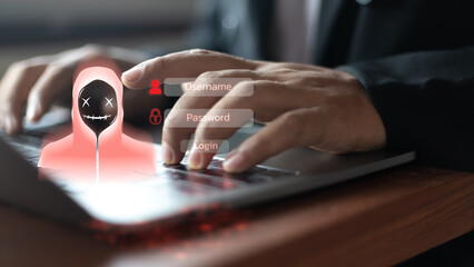 Hacker hologram with a hooded figure on a laptop showing username and password login screen....
