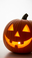 Illuminated carved pumpkin, classic Halloween symbol, displaying a smiling face, evokes festive spirit and autumnal atmosphere