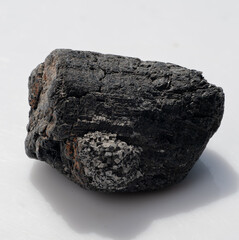 Raw Black Tourmaline Crystal Chunk with Granular Inclusions, Dark Tone, Mineral Specimen, Gemstone, Geology, Rough Stone Texture, Shadow Effects