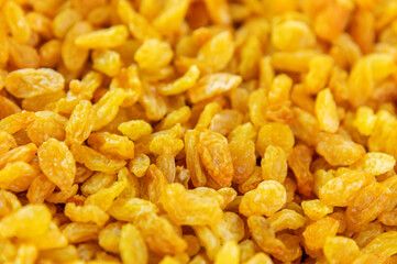 Close up of lots of golden raisins. Dried seedless grapes