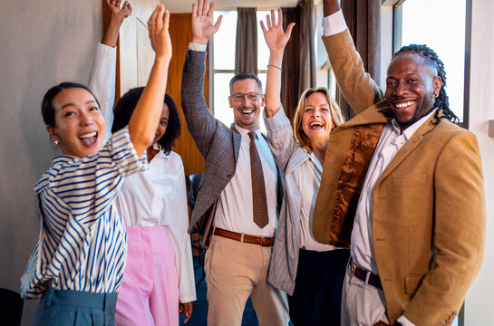Portrait of diverse group of business people in modern workplace looking at camera.
