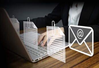  Business professional sending email with multiple document attachments using laptop computer,...