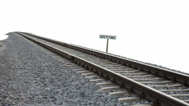 Railway Track with Safety First Sign on Gravel Path