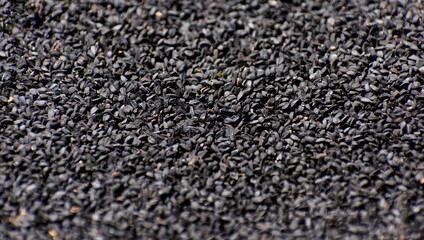 Close-up Photo of Black Cumin Seed in a Textured Surface Background