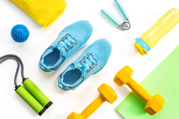 Gym sports equipment with sneakers and dumbbells, top view. Fitness concept