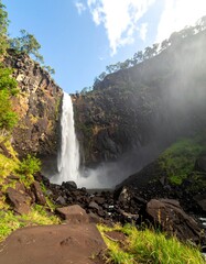 Majestic waterfall cascading down rocky cliff face
