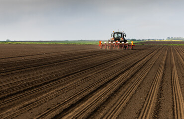 Obraz premium Tractor and seeder for sowing corn