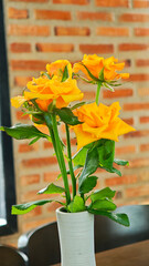 Yellow roses in a vase on the table