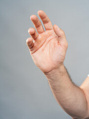 Male Hand Palm Close-Up on Gray Background, Open Gesture