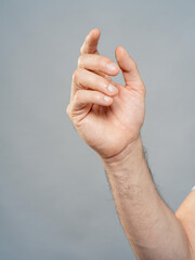 Male Hand Palm Close-Up on Gray Background, Open Gesture