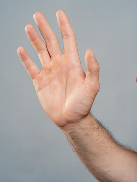 Male Hand Palm Close-Up on Gray Background, Open Gesture