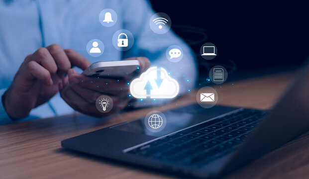 User interacts with a smartphone and a laptop, showing cloud computing, data transfer, and digital services with glowing icons for security, connectivity, and communication. Modern technology concept.