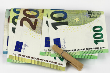 European Union banknotes folded and held together with a laundry clip