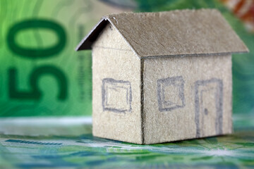 Finance, real estate, and paper money in Swiss francs, as well as a model of a house
