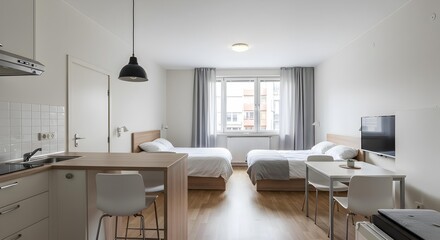 Bright Minimalist Single Bedroom with Desk, Laptop, and Bed Bathed in Natural Sunlight.