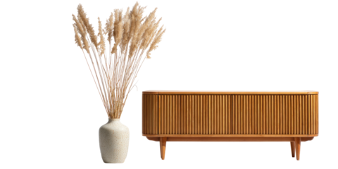 Light beige pampas grass in a cream vase next to a light brown wooden cabinet