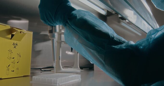 Close-Up: Doctor&rsquo;s Gloved Hands Conducting a Hazardous Laboratory Experiment