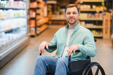 Man in wheelchair shopping for groceries in supermarket