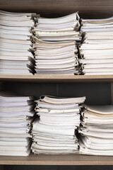 WellOrganized Stacks of Papers Neatly Arranged on a Sturdy Wooden Shelf for Easy Access