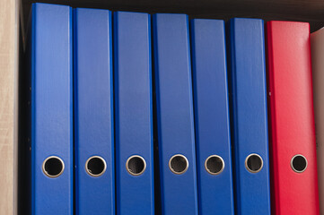 Bright and Colorful Office Binders Organized Neatly on a Shelf for Efficient Storage Solutions