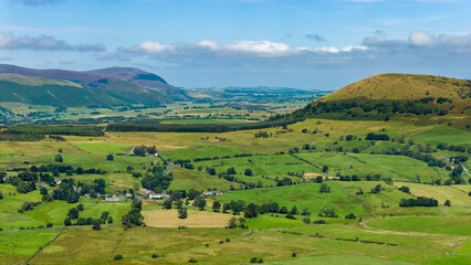 Aerial drone view of rolling green hills, fields, and farmland in the Lake District © whitcomberd