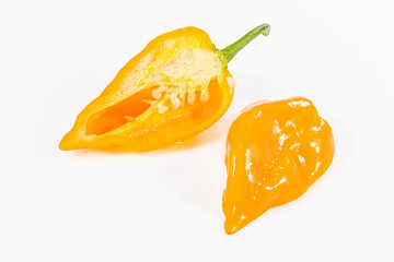 very spicy beautiful orange habanero pepper cut in half on white background