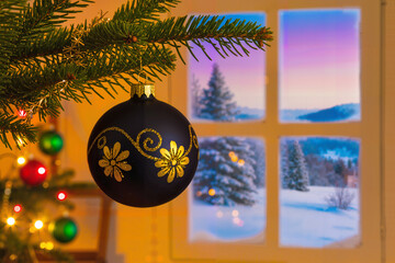 Black Christmas Ornament with Golden Patterns by Fireplace. Matte Black Bauble with Elegant Gold Design and Fireplace Glow. Festive Black and Gold Christmas Ball in Cozy Room.