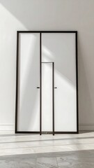 Modern minimalist interior design featuring a set of three framed doors with black frames and white panels, illuminated by natural light.