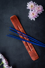 air freshener sticks with flowers on dark background top view