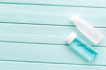 Organic cosmetics for face clearing with facial tonic, mycelial water mint green wooden background top view copy space