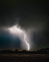 Lightning strikes through a rain downpour at close range