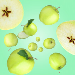 Fresh green apples swirling in air against turquoise background