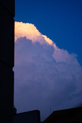 Majestic clouds illuminated by sunset hues against a deep blue sky.