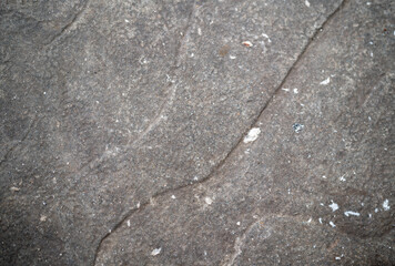 Textured surface of weathered stone with subtle patterns.