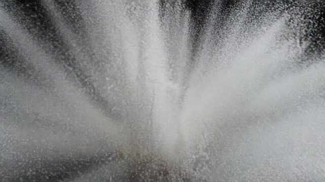 Abstract sand motion. Gray grains on black background. Dust particles swirl. Defocused particles. 4k loop storm. Explosion of silver particles. Big explosion. Random particle turbulence.