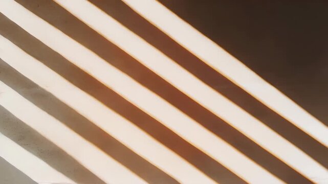 Parallel lines of sunlight slowly moving across a surface