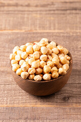 Organic hazelnuts in a wooden bowl. Vegan food concept. 