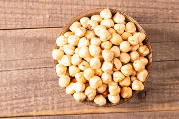 Organic hazelnuts in a wooden bowl. Vegan food concept. 