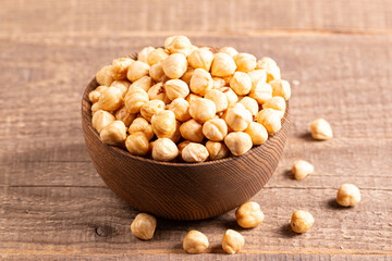 Organic hazelnuts in a wooden bowl. Vegan food concept. 