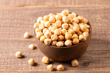 Organic hazelnuts in a wooden bowl. Vegan food concept. 